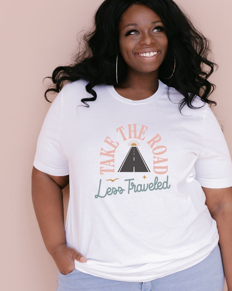 Front of a model wearing a size 2XL Road Less Traveled Road l Short Sleeve Graphic Tee in White by Simply Sage Market. | dia_product_style_image_id:283742